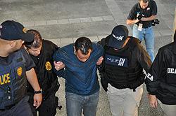 Agents escort defendant Christian Soto-Mujica to the Federal Building