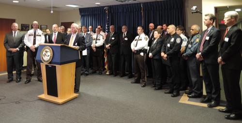 SAC Riley is surrounded by partner Police Chiefs, Sheriffs, US Attorney Andrew Luger, and County Prosecutors.