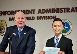 Former Associate Deputy Attorney General and local DEA Education Foundation Board Member, Charlie Blau, presents 3rd place winning check to Nate Trillo.
