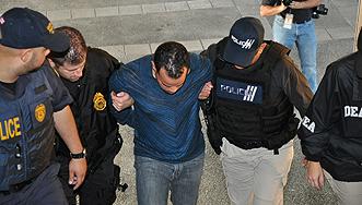 Agents escort defendant Christian Soto-Mujica to the Federal Building. 