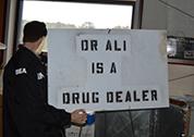 This sign stating “Dr. Ali is a drug dealer”  was found at Dr. Ali’s clinic. DEA learned that the sign was placed in front of the clinic by unknown persons and removed by Dr. Ali.