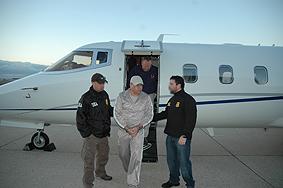 DEA agents escort Esteban Rodriguez-Olivera upon his arrival in the U.S.