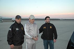 DEA agents escort Esteban Rodriguez-Olivera upon his arrival in the U.S. 