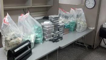 Drugs, weapons, and money seized as a result of the investigation.