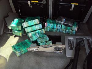 Bricks containing 25,000 street-ready glassine envelopes of heroin found in the hidden compartment.