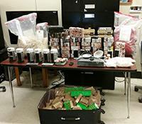 Seized heroin, drug paraphernalia and equipment used at the heroin mill to process and package heroin.