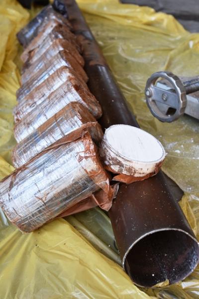 Heroin packaged and molded to fit inside a container in axle
