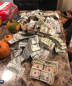 A court authorized search yielded cash and 215 glassine envelopes of suspected heroin/fentanyl stamped with an image of a kneeling skeleton and the brand name “Pray for Death.”