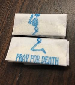 A court authorized search yielded cash and 215 glassine envelopes of suspected heroin/fentanyl stamped with an image of a kneeling skeleton and the brand name “Pray for Death.”
