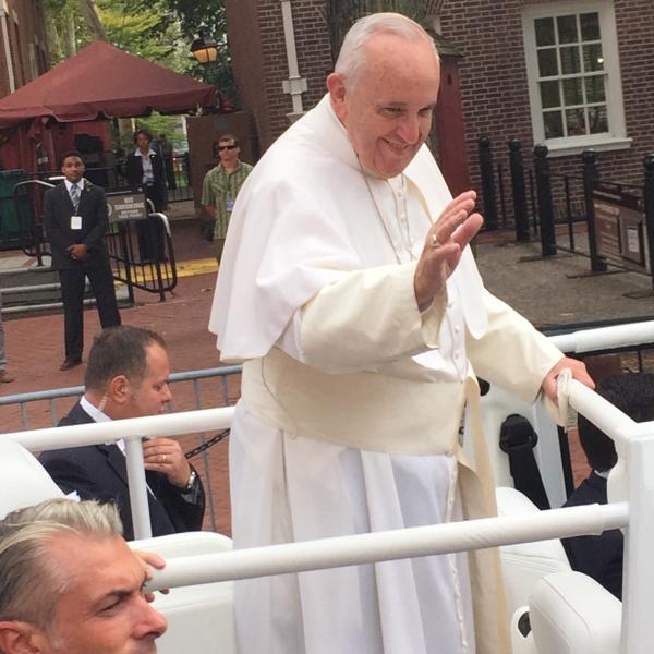 Pope Francis waving to the crowd at Independence Hall.  