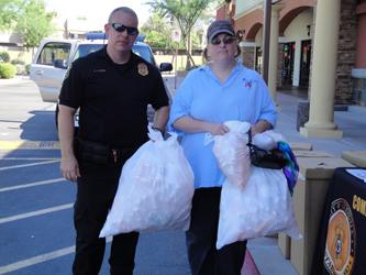 Glendale PD Officer Andrew Lynes and local resident at collection site in Glendale, AZ.