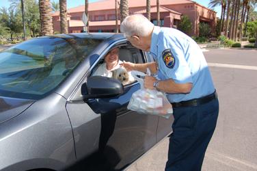Surprise PD Officer greets driver and his dog in Surprise, AZ