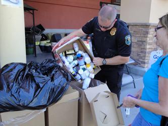 Glendale PD Officer filling collection box