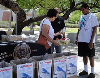 Mother and son dropping their unwanted medicines at collection site in Tempe, AZ.