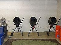 Photos of spice manufacturing at various stages.  Cement mixers, bulk damiana leaf in bags and bins.