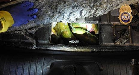 During the search of a vehicle, agents located an access panel in the rear cargo area which accessed the gas tank where they located 53 pounds of heroin. 