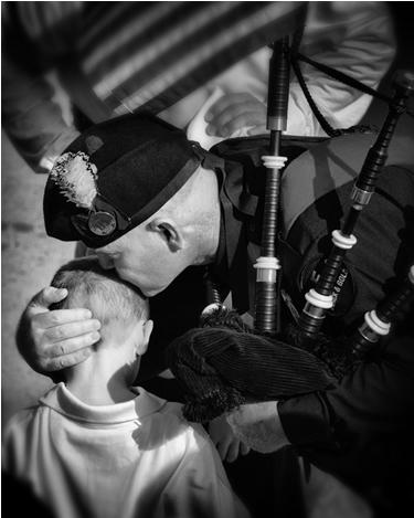 (L) DEA Special Agent Kevin Donnelly consoles the son of SA Tom Byrne upon arrival of his body at Washington Dulles Airport, 2008.  