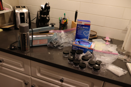 Station containing heat-sealer, plastic baggies, and nitrile gloves